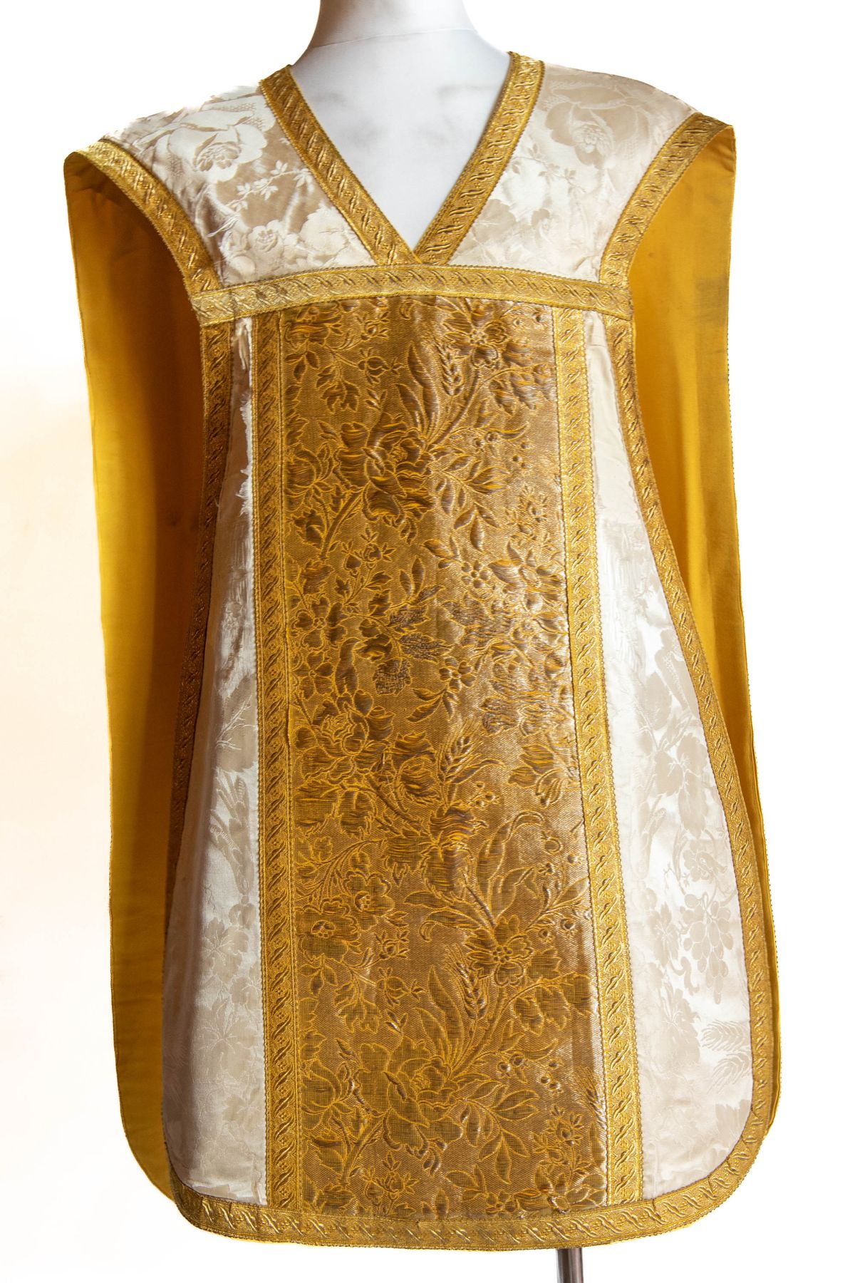 White chasuble woven in gilded thread with floral designs,